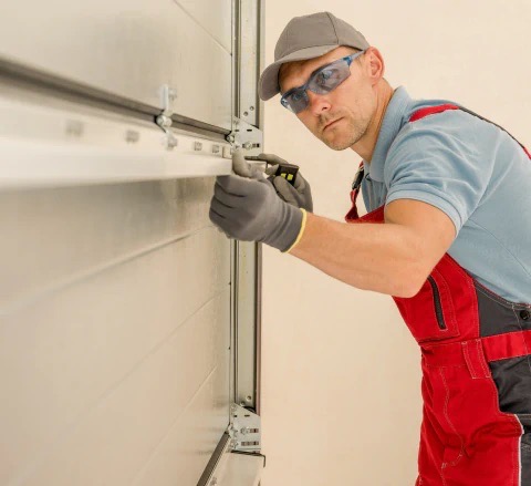 worker installing brand new residential garage door bowling green ky
